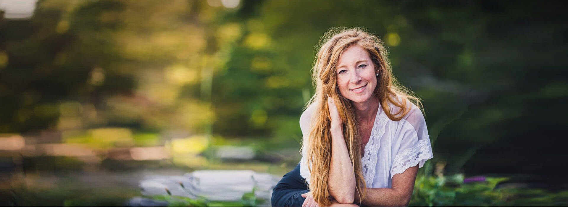 Stacey sitting in the forest