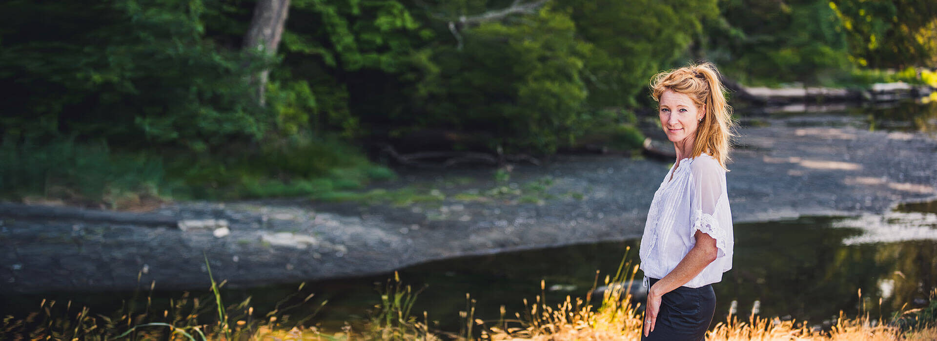 stacey beside a river